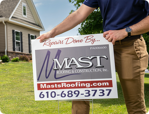Man holding a sign displaying contact details.